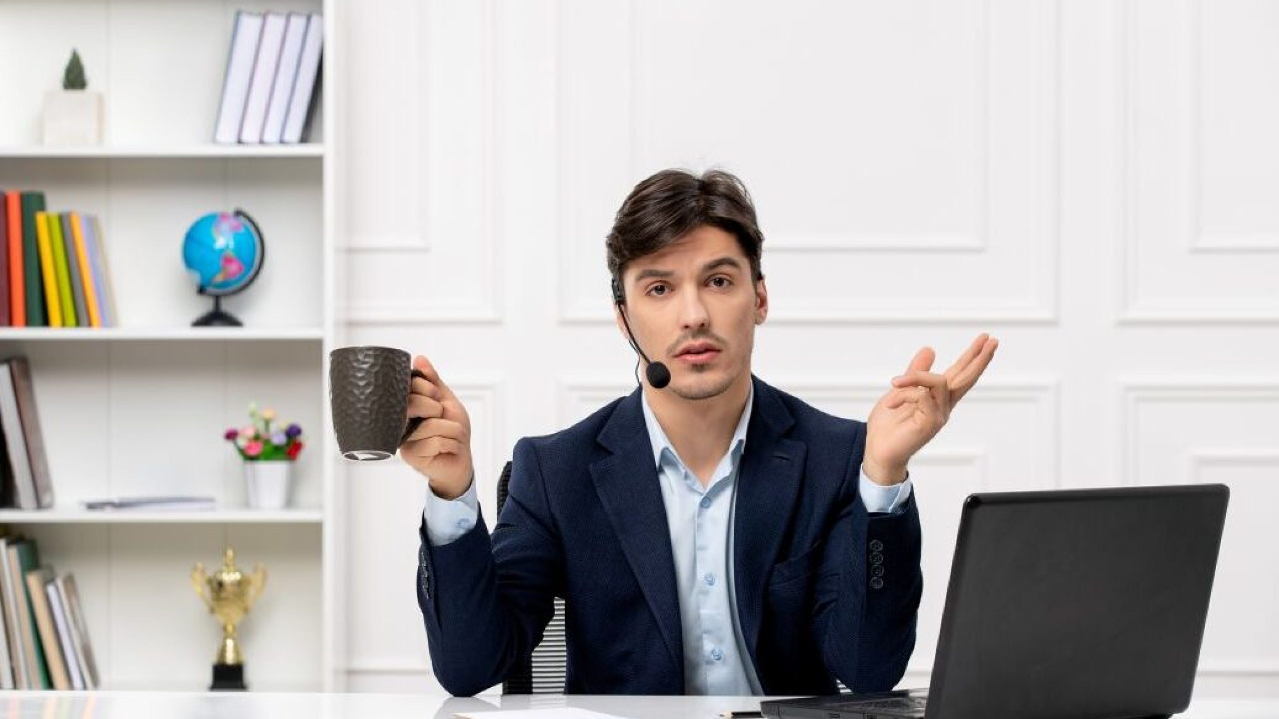 customer-service-handsome-guy-with-headset-laptop-suit-waving-hands-holding-cup
